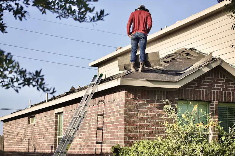 Professional roofer working on a residential roof in Eagle